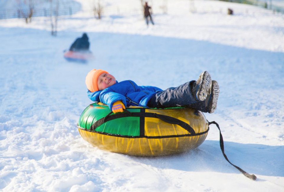 Lay back and let gravity do all the work with the best snow turning in Connecticut for families! Photo courtesy of Canva