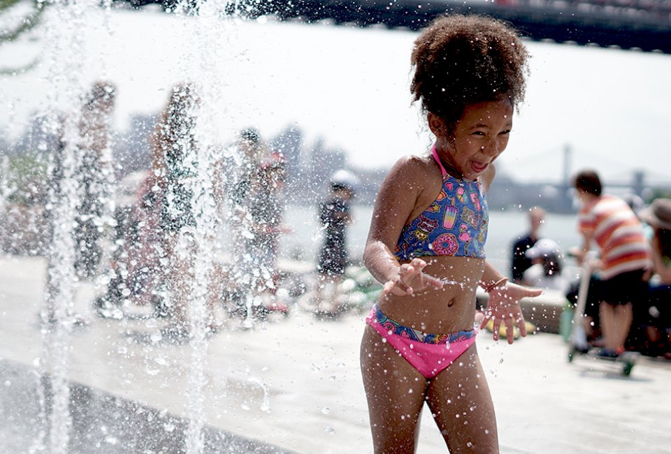 The splash pad in Domino Park puts a smile on faces young and old. Photo by Jody Mercier