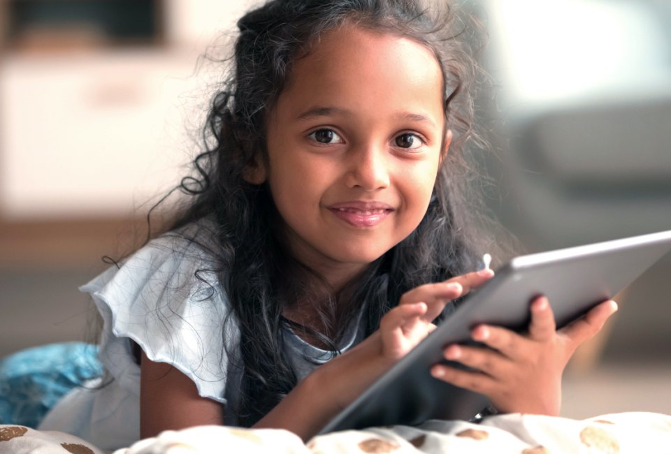 Go ahead. Hand them the iPad; these websites for kids are fun and at least a little educational. Photo courtesy of Bigstock