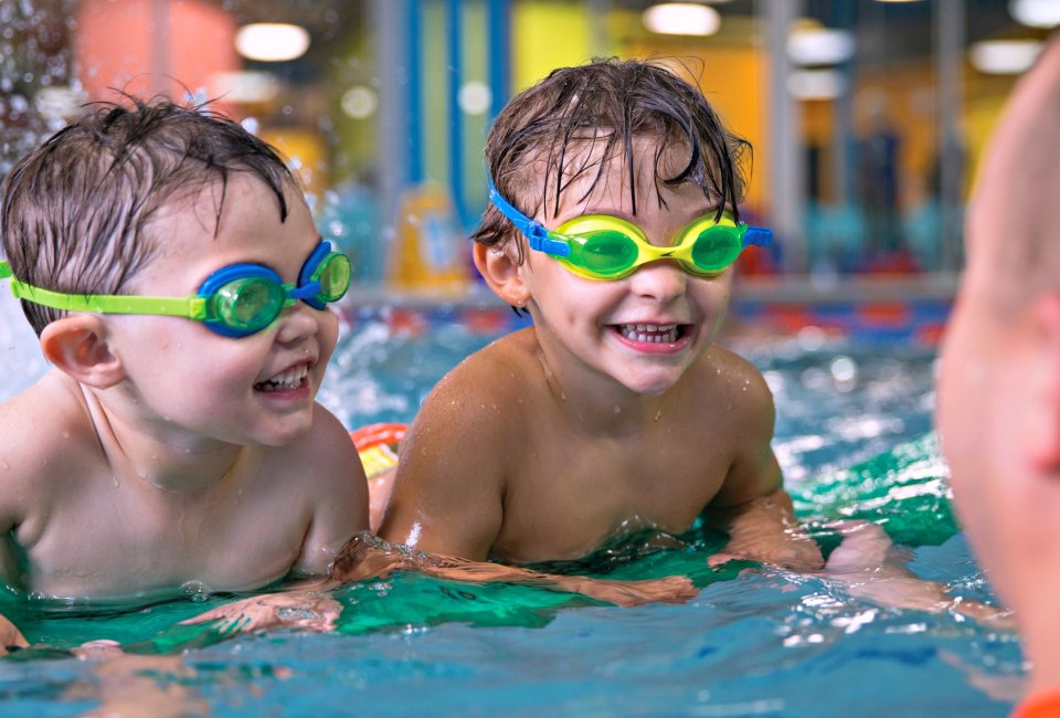 All sibs in the pool! Small group sessions are available now at Goldfish. Photo courtesy of Goldfish Swim School