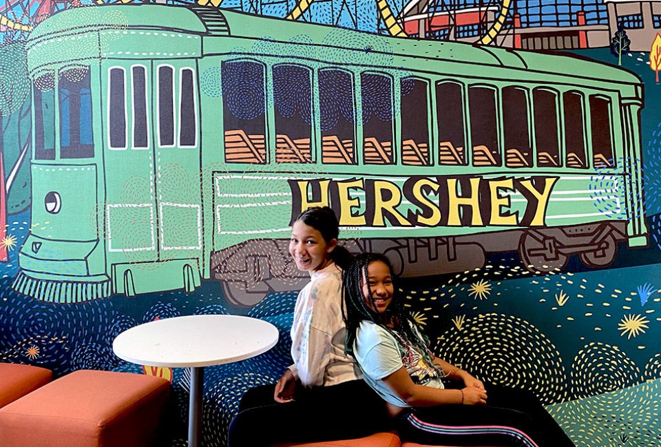 Pose for a post-card worthy photo in front of the Hershey-themed mural at Tru by Hilton Hershey Chocolate Avenue during your stay. 