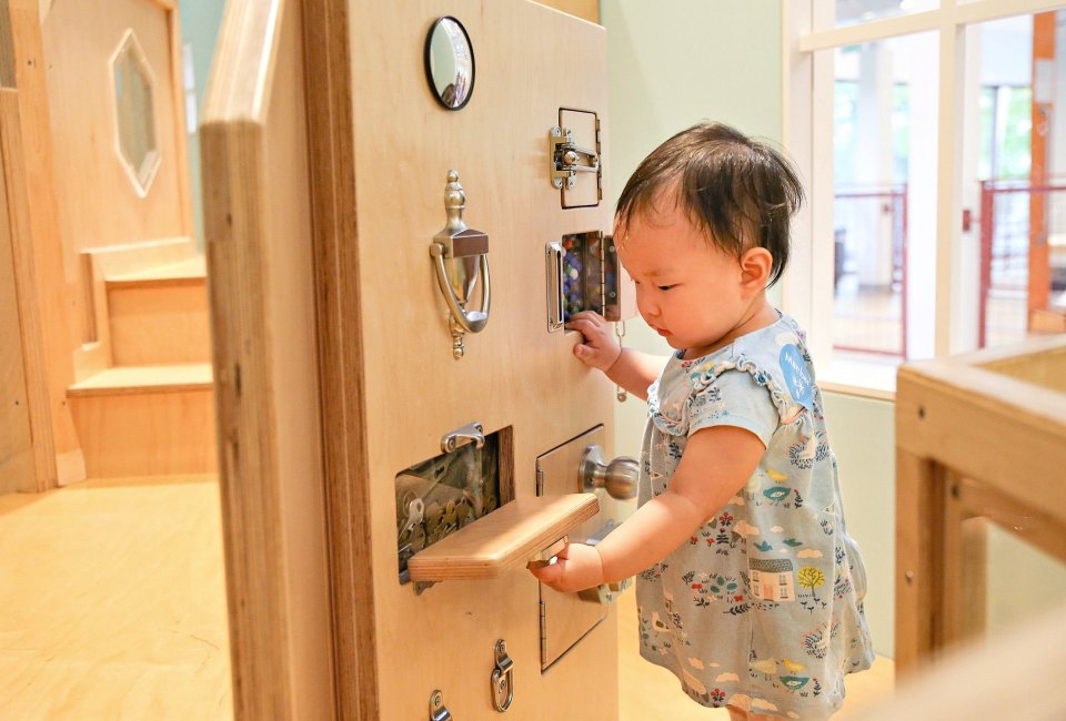 Discover the Latch Wall in the Brain Building Together space for 0-3 year olds. Photo courtesy of Discovery Museum