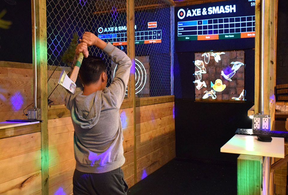 Experience the thrill of throwing an axe at a wooden target at Axe & Smash.