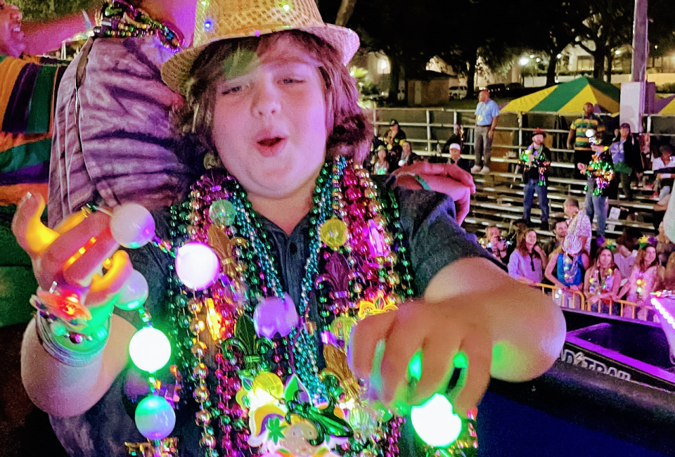 <i>Kids absolutely love catching Mardi Gras beads.</i>