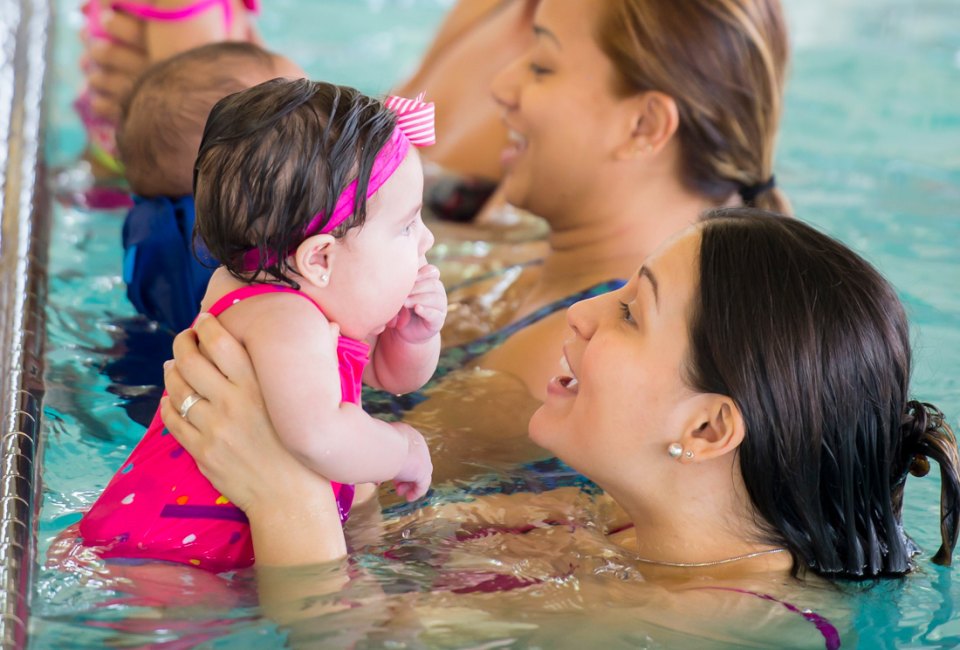 Mommy & Me swimming classes are a great way to get babies used to the water while having fun. Photo by Fat Camera courtesy of Canva.