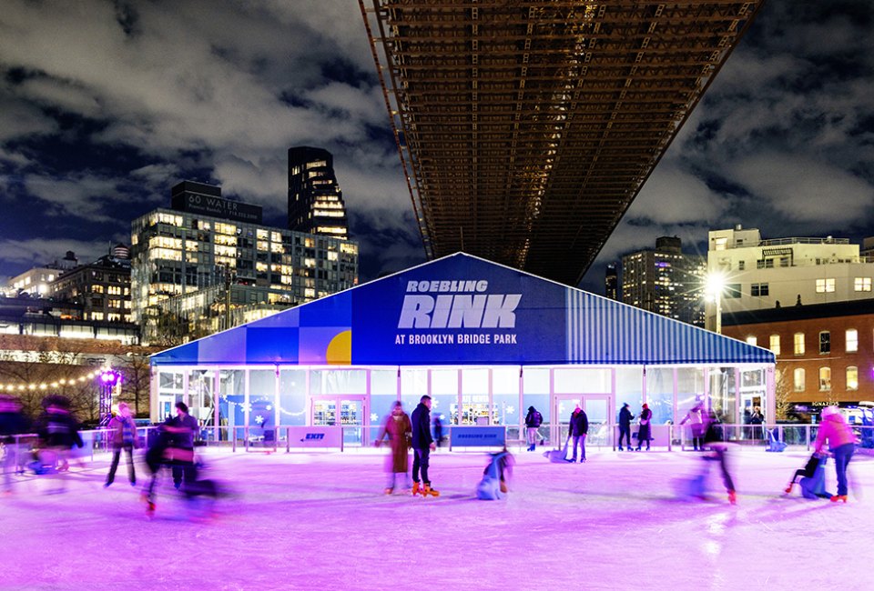 Skate beneath the historic Brooklyn Bridge while taking in the iconic views of the Manhattan skyline at Roebling Rink. Photo courtesy of venue