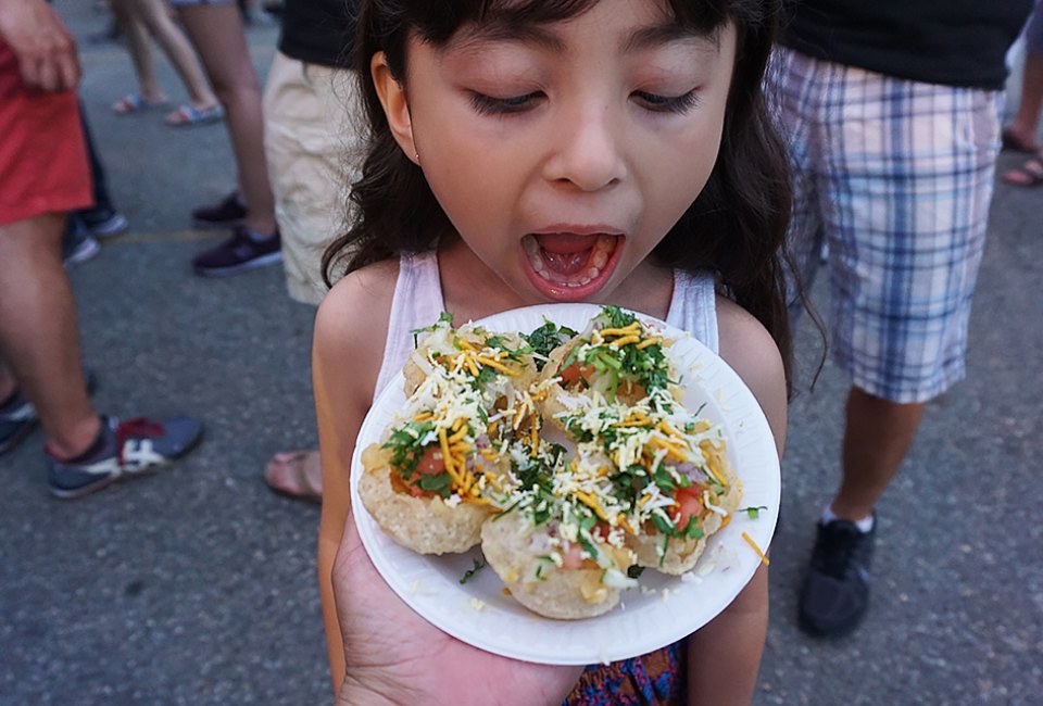 The Queens International Night Market is a large, family-friendly, open-air night market in Queens, featuring vendors selling merchandise, art, and food! Photo by Sharon Medina for the Queens Night Market