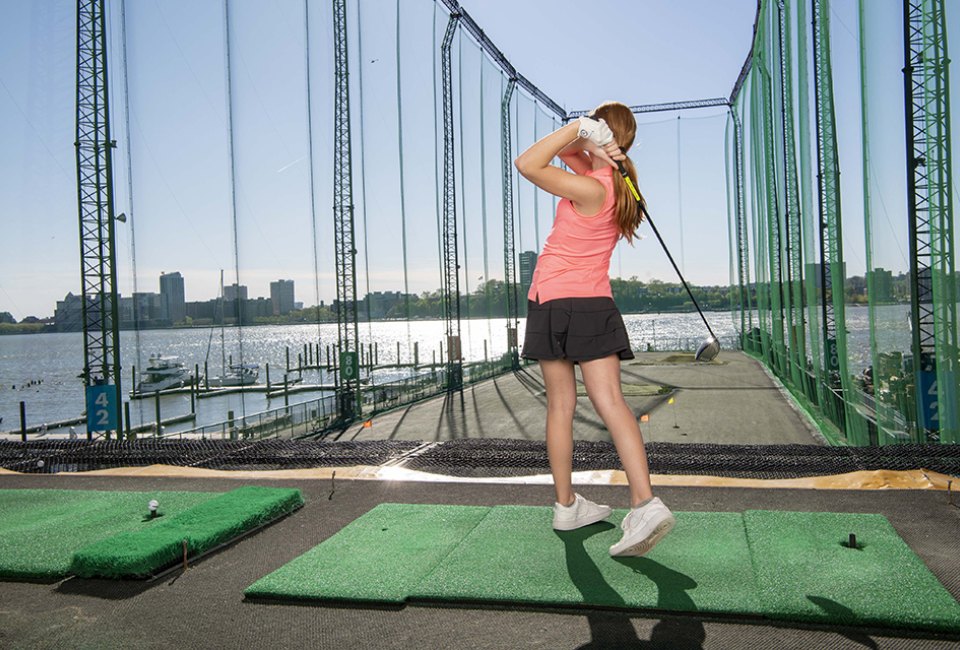 Swing into action with a golf summer camp at Chelsea Piers. Photo courtesy of Chelsea Piers