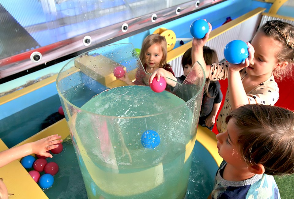 Twinkle Playspace's water table let’s kids toss objects into its whirlpool.