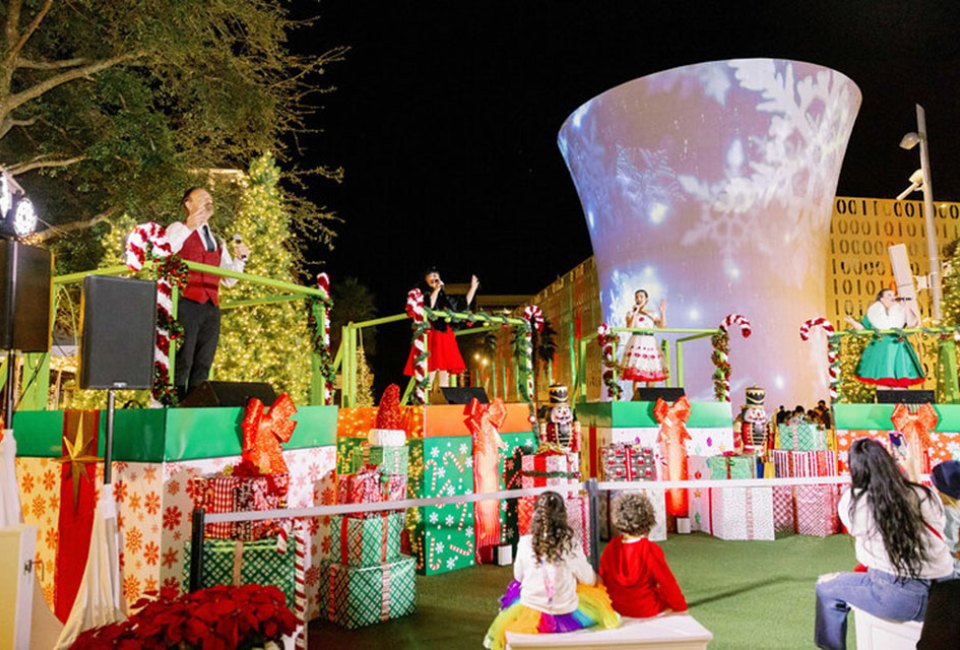 Lake Nona's holiday festival features fun activities for the whole family, including snowfalls, live shows, and entertainment. Photo courtesy of the festival