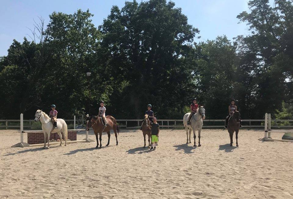 Campers get hands on riding experience at horseback riding camp. Photo from Out of Reach Farm