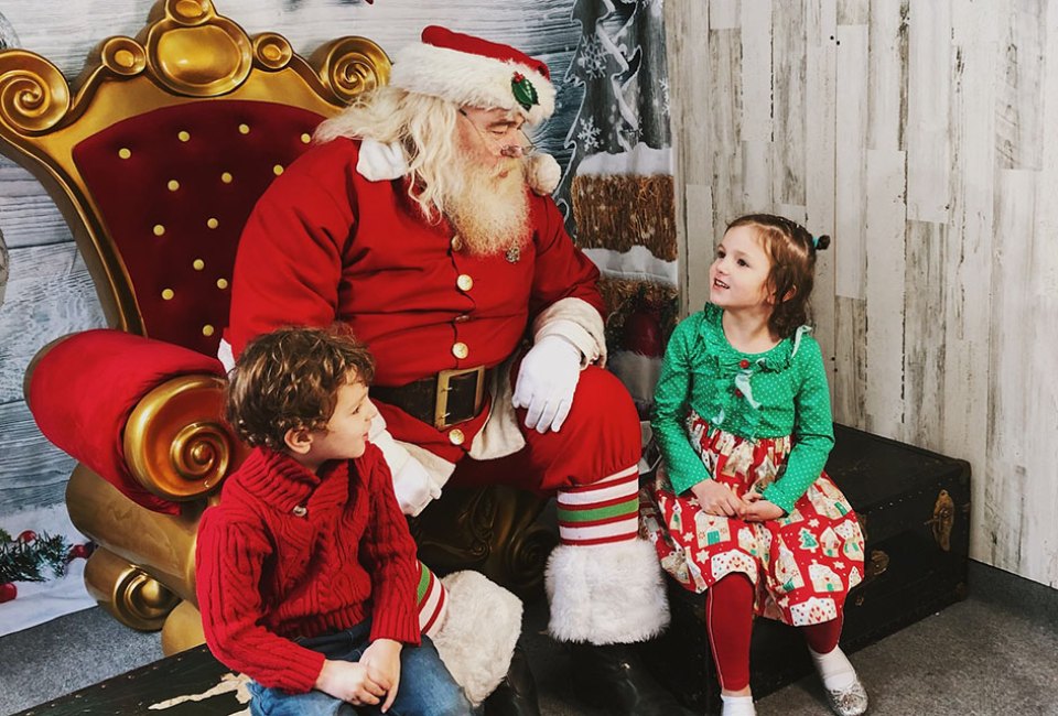 Kids can visit Santa and ride the carousel, Ferris wheel, and train at Christmas Village in Philadelphia. Photo courtesy of the event