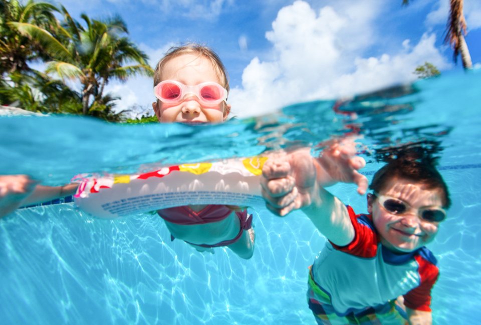 Keep kids laughing and splashing in the pool with these fun games you can play anywhere! Photo by Blue Orange Studio courtesy of Canva