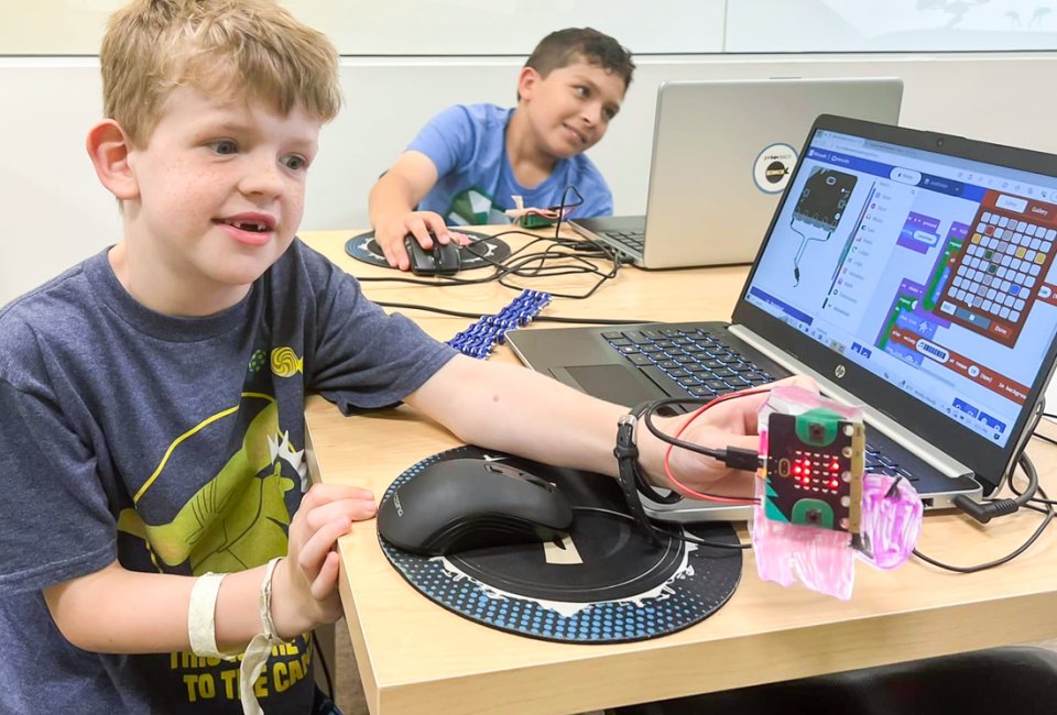 Hone their computer skills with the best coding classes for kids in Boston! Photo courtesy of Code Ninjas 