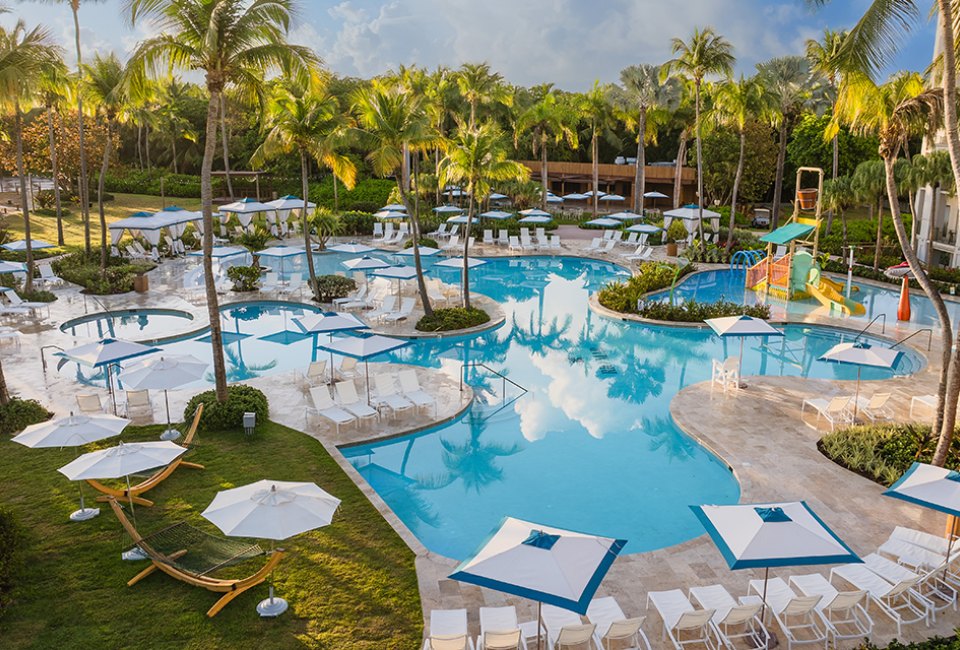 Best Resorts and Hotels in Puerto Rico for Families Splash into the lagoon-style swimming pool and doze off under a beach cabana at Wyndham Rio Mar. Golf & Beach Resort. Photo courtesy of the resort