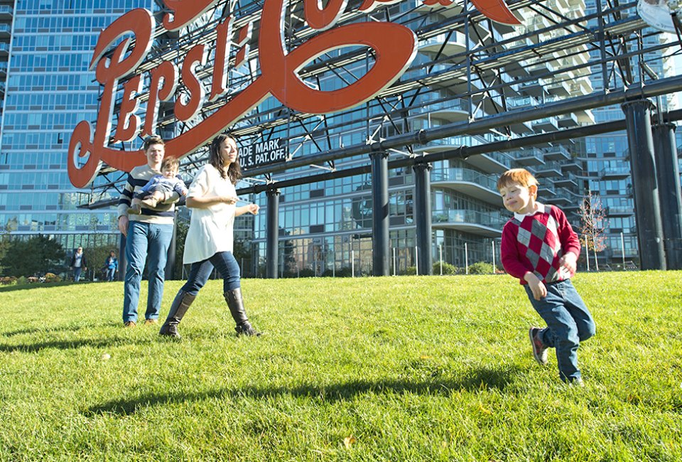 Play under the  iconic Pepsi Cola sign. Photo by Sidney Ng