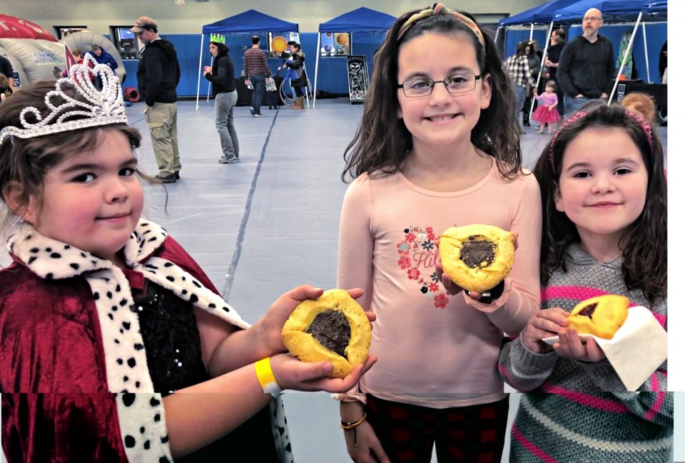 Kids display their hamantaschen at the Zoo Purim Carnival in Stamford. Photo by Ally Noel