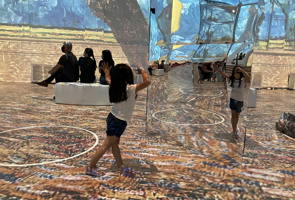 Mirrors put kids right in the middle of the art at Immersive  Van Gogh. Photo by Maureen Wilkey 
