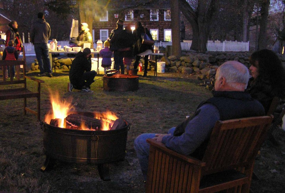 Visitors gather around two outdoor fires next to Connecticut’s oldest house to eat, drink, and be merry.