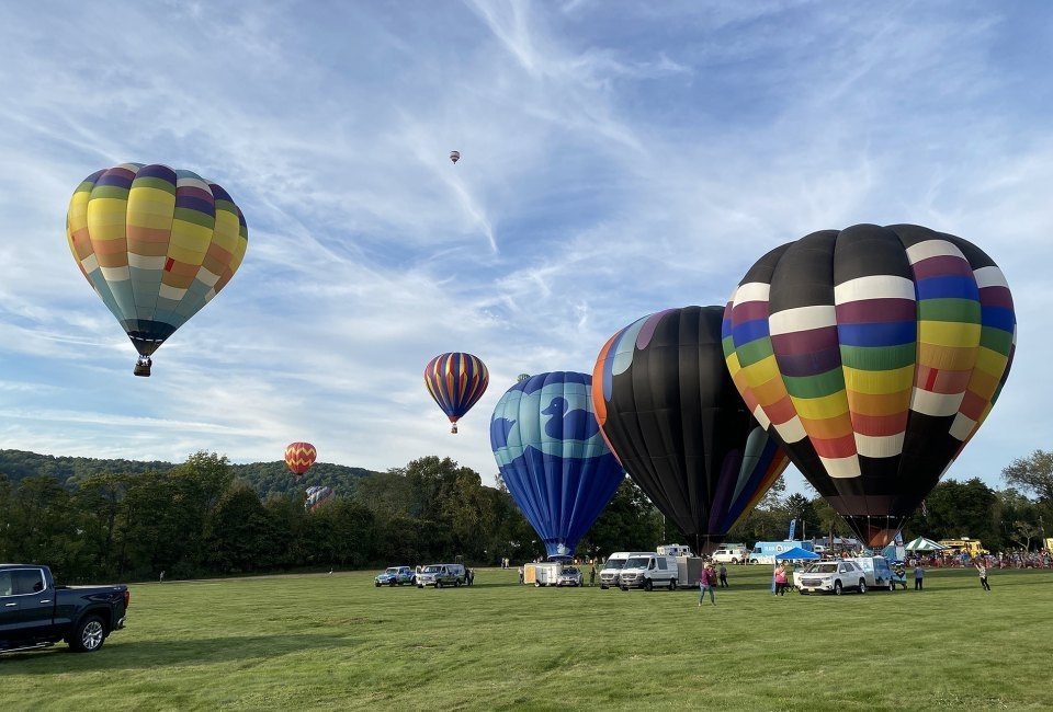 Enjoy the sight of hot air balloons and take part in activities like tethered rides at the Warren County Hot Air Balloon Festival. Photo courtesy of the festival